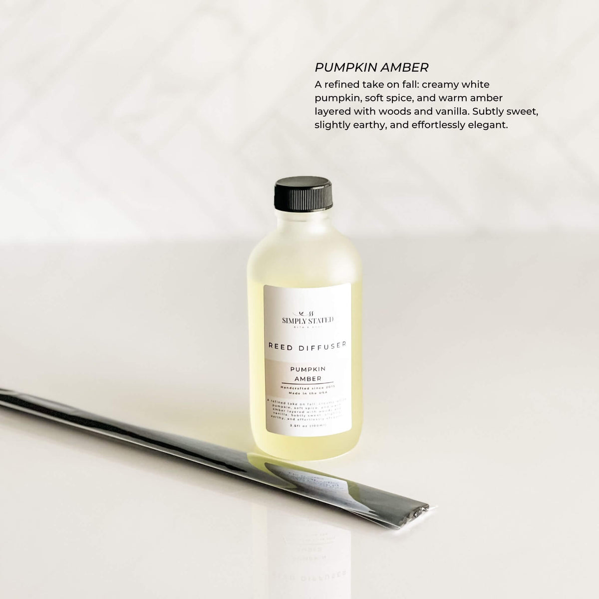 Simply Stated Fall Reed Diffuser in Pumpkin Amber with reeds and neutral background