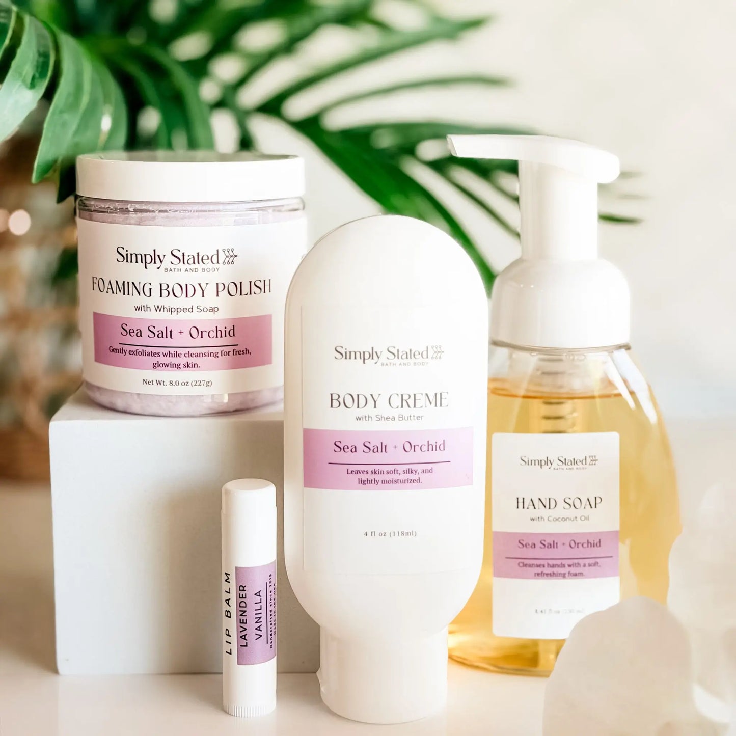 Simply Stated Self Care Starter Kit in Sea Salt and Orchid — foaming body polish, body creme, foaming hand soap, and Lavender Vanilla lip balm, handcrafted in Fort Morgan Colorado