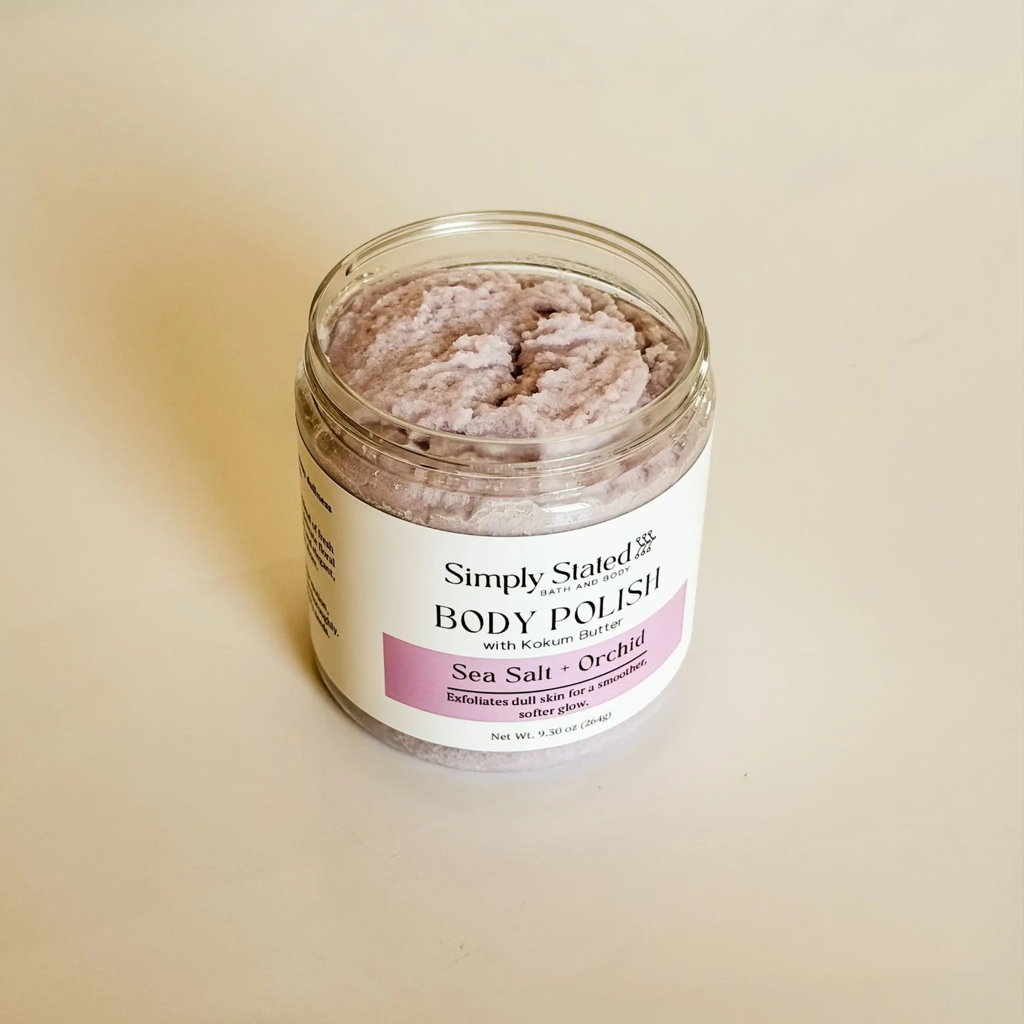 Simply Stated Bath & Body Sea Salt + Orchid Body Polish jar open, top-down view showing grainy texture
