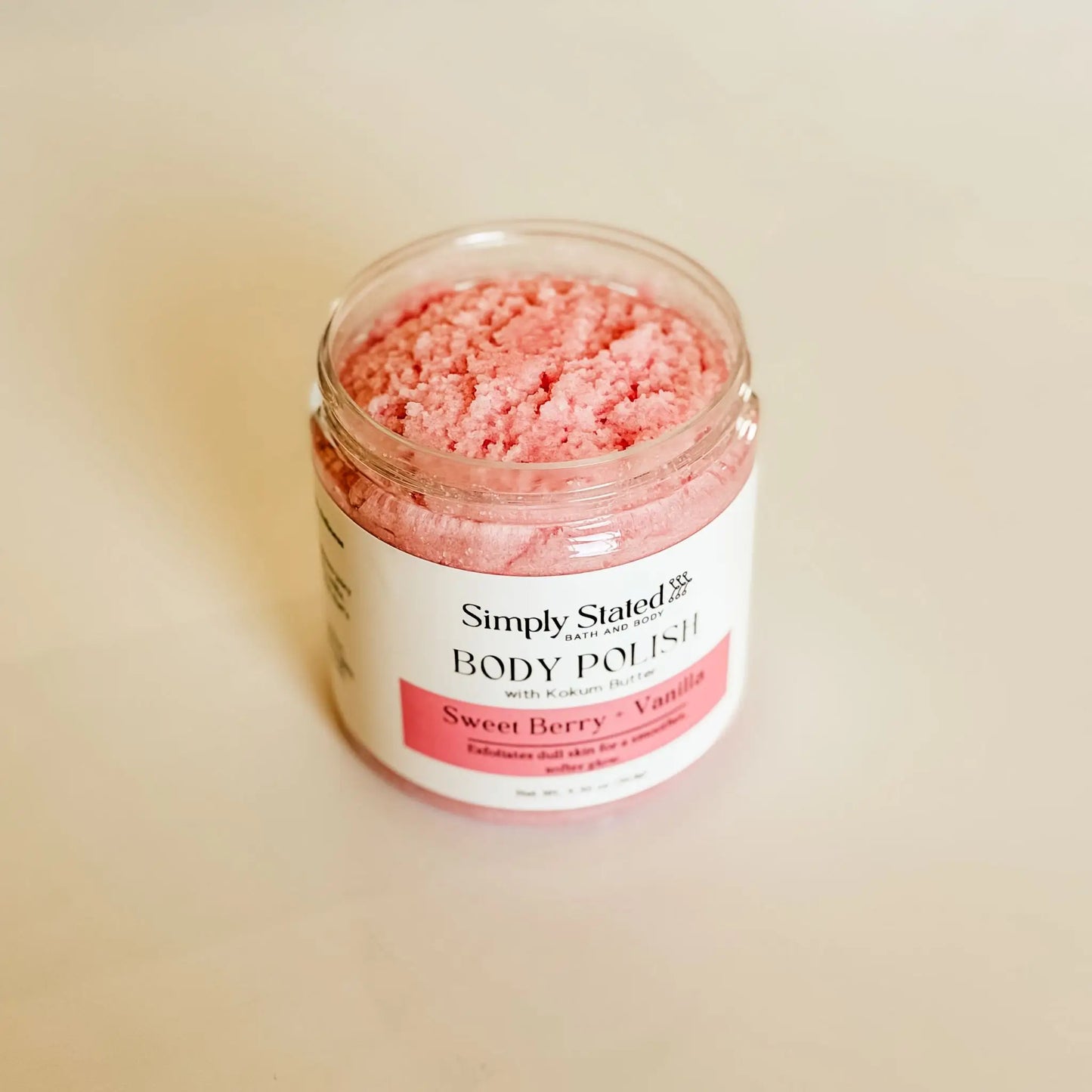 Sweet Berry + Vanilla Body Polish with Kokum Butter by Simply Stated Bath & Body, open jar showing pink sugar scrub