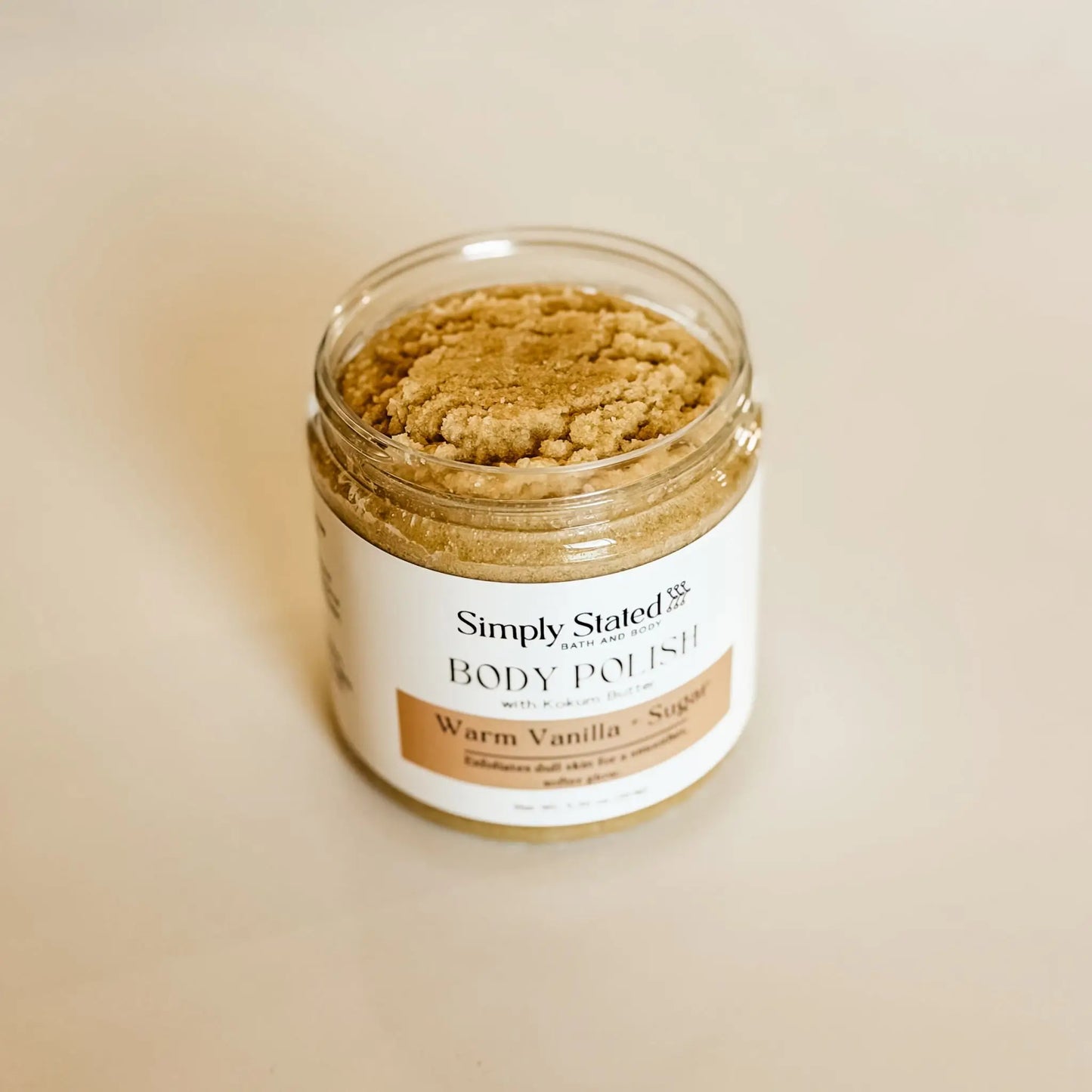Warm Vanilla + Sugar Body Polish with Kokum Butter by Simply Stated Bath & Body, open jar showing tan sugar scrub