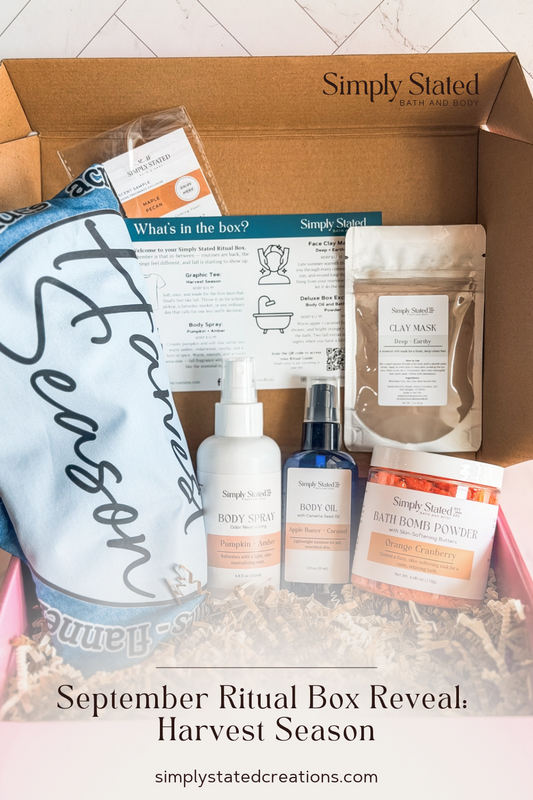 September Ritual Box with bath bomb powder, body spray, body oil, clay mask, and graphic tee for harvest season.