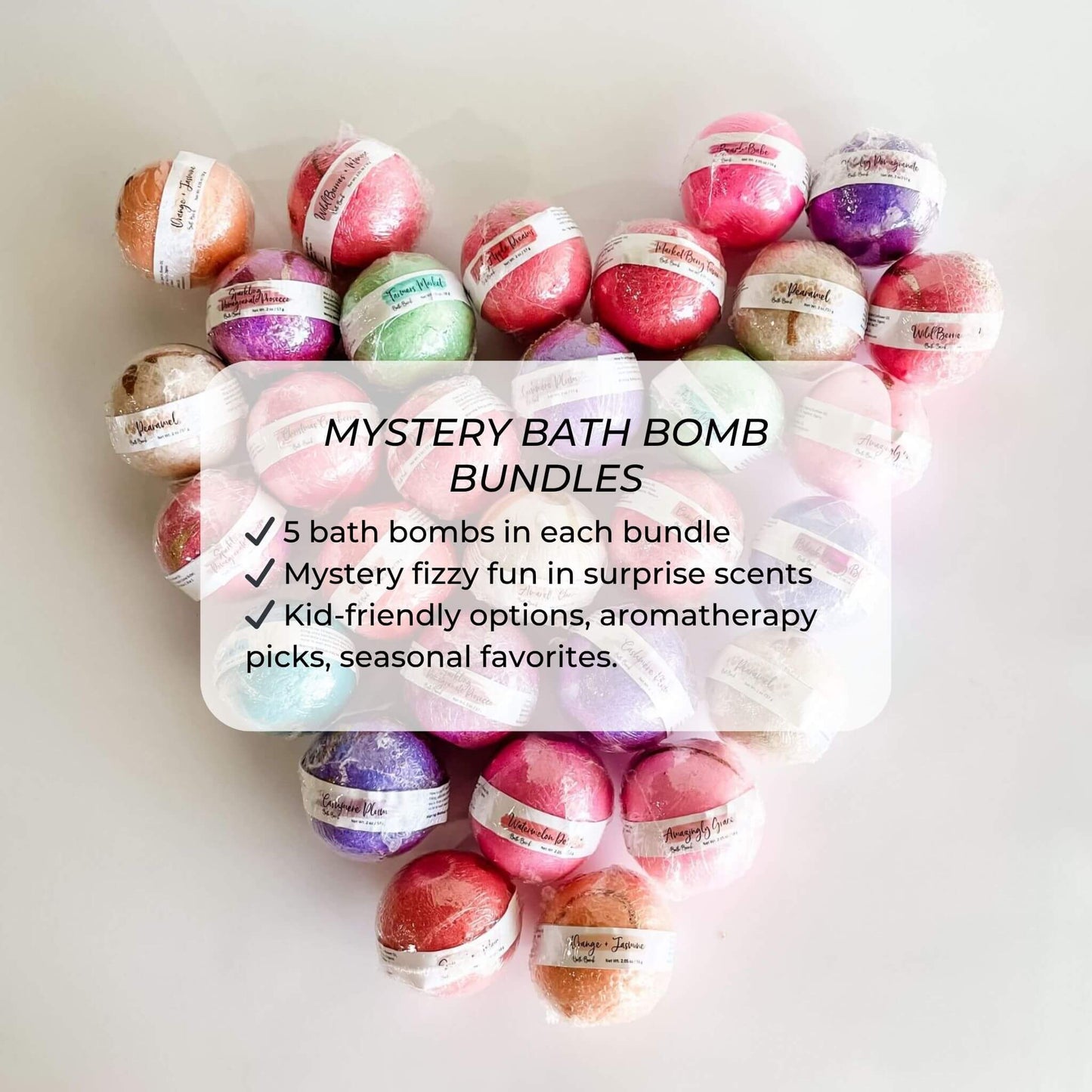 Heart-shaped display of colorful wrapped bath bombs labeled “Mystery Bath Bomb Bundles”