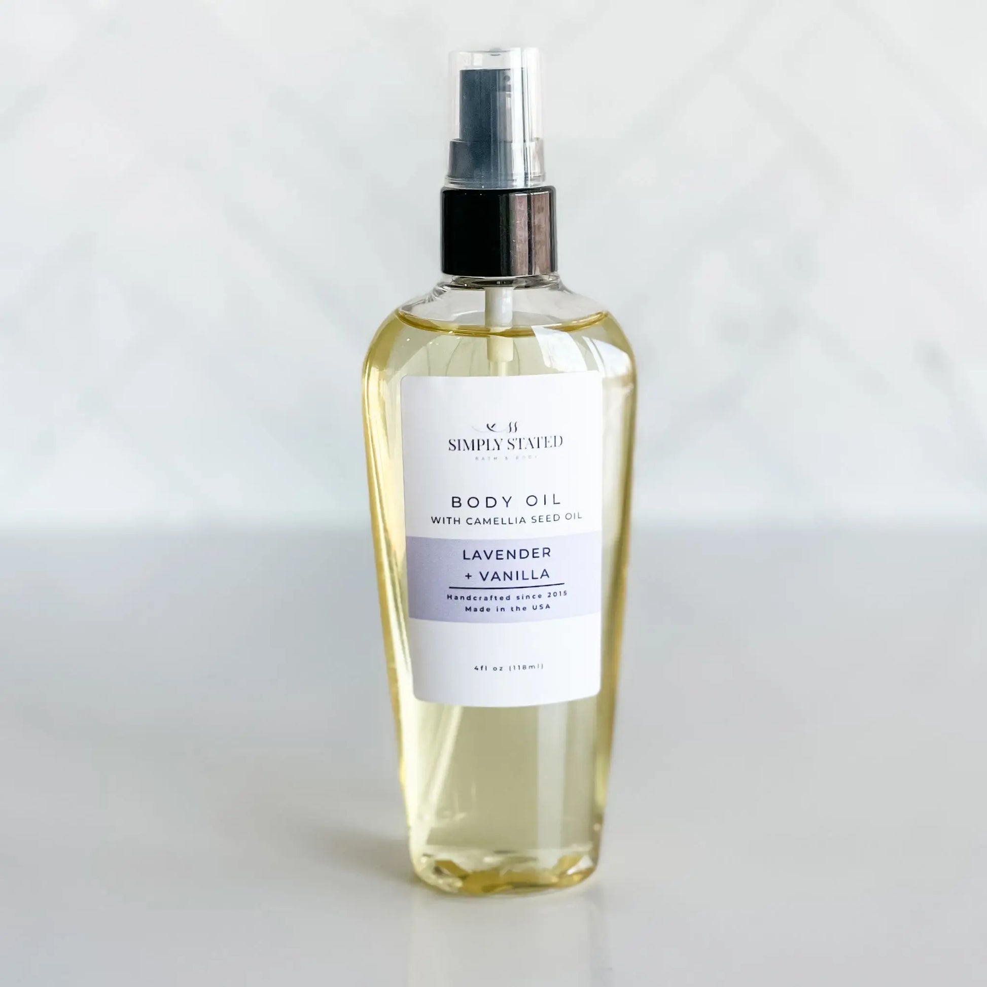 Body oil bottle labeled 'Lavender & Vanilla' on a white background