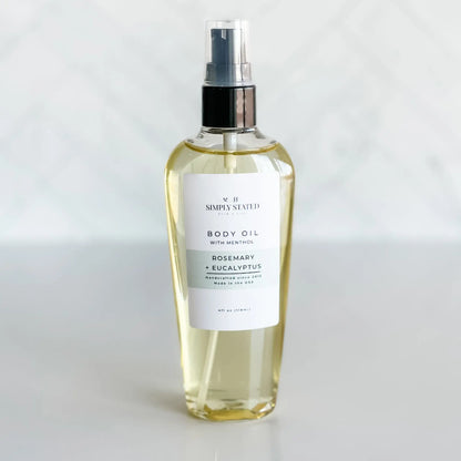 Body oil spray bottle with a label on a white background