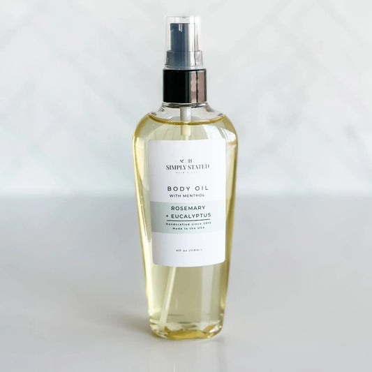 Body oil spray bottle with a label on a white background