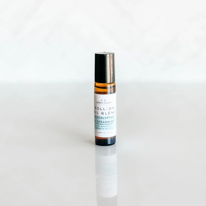 Roll-on oil blend bottle on a white background