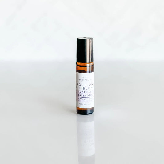 Roll-on bottle of essential oil blend on a white background