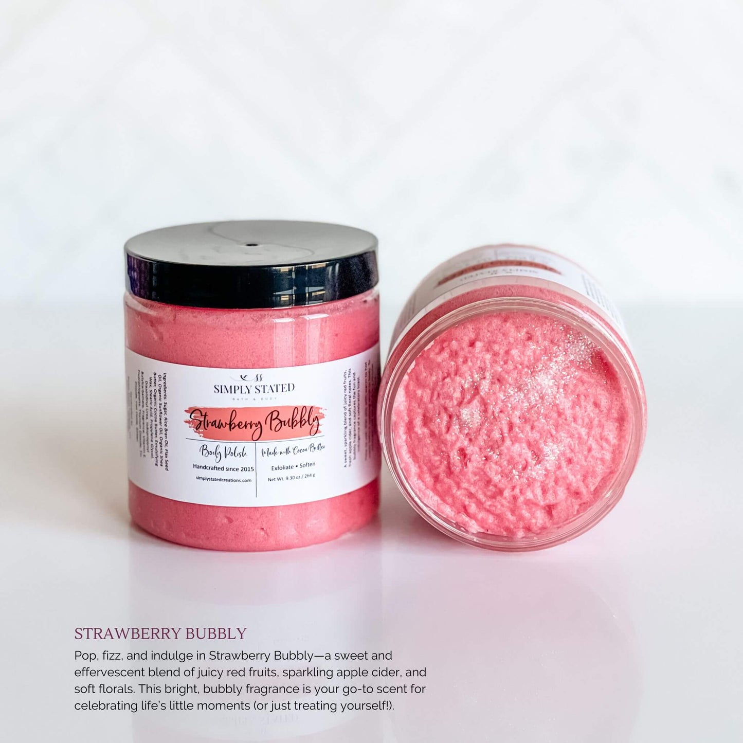 Simply Stated Bath & Body Strawberry Bubbly Body Polish in a jar with bright pink whipped exfoliating scrub, featuring a pink label and black lid, displayed on a white background.