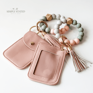 Card Case in dusty pink rose. Includes silicone beaded bracelet keychain (white marble, light dusty rose, grey) and matching dusty rose pink tassle