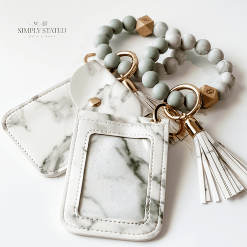 Card Case in White Marble. Includes silicone beaded bracelet keychain and tassle