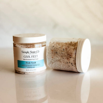 Simply Stated Cool Feet Pedi Soak jar open showing mineral salt crystal texture — mentholated foot soak with magnesium sulfate and activated charcoal, handcrafted in small batches in Colorado