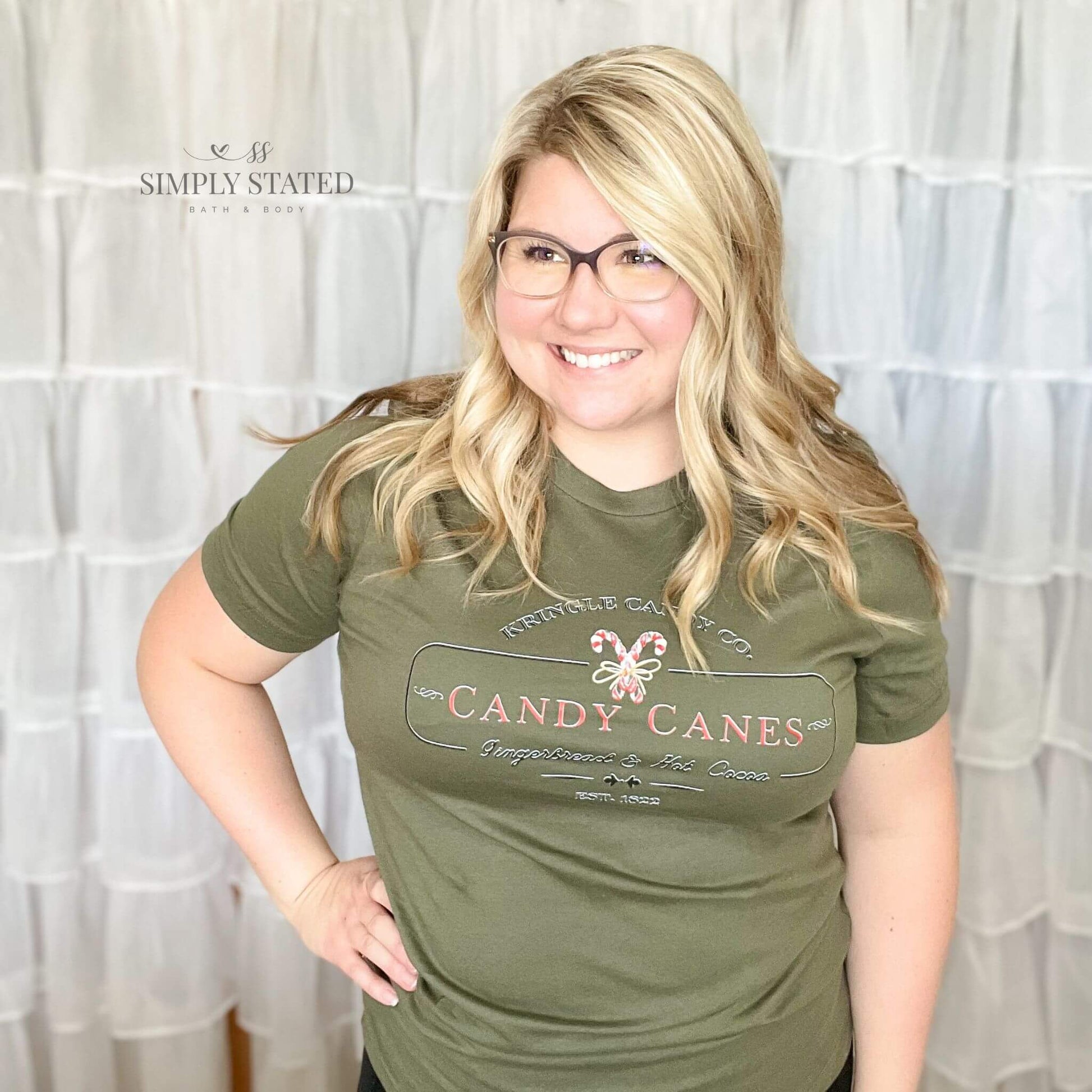 Graphic Tee in Military Green with "Kringle Candy Co. Candy Canes, Gingerbread, & Hot Cocoa."