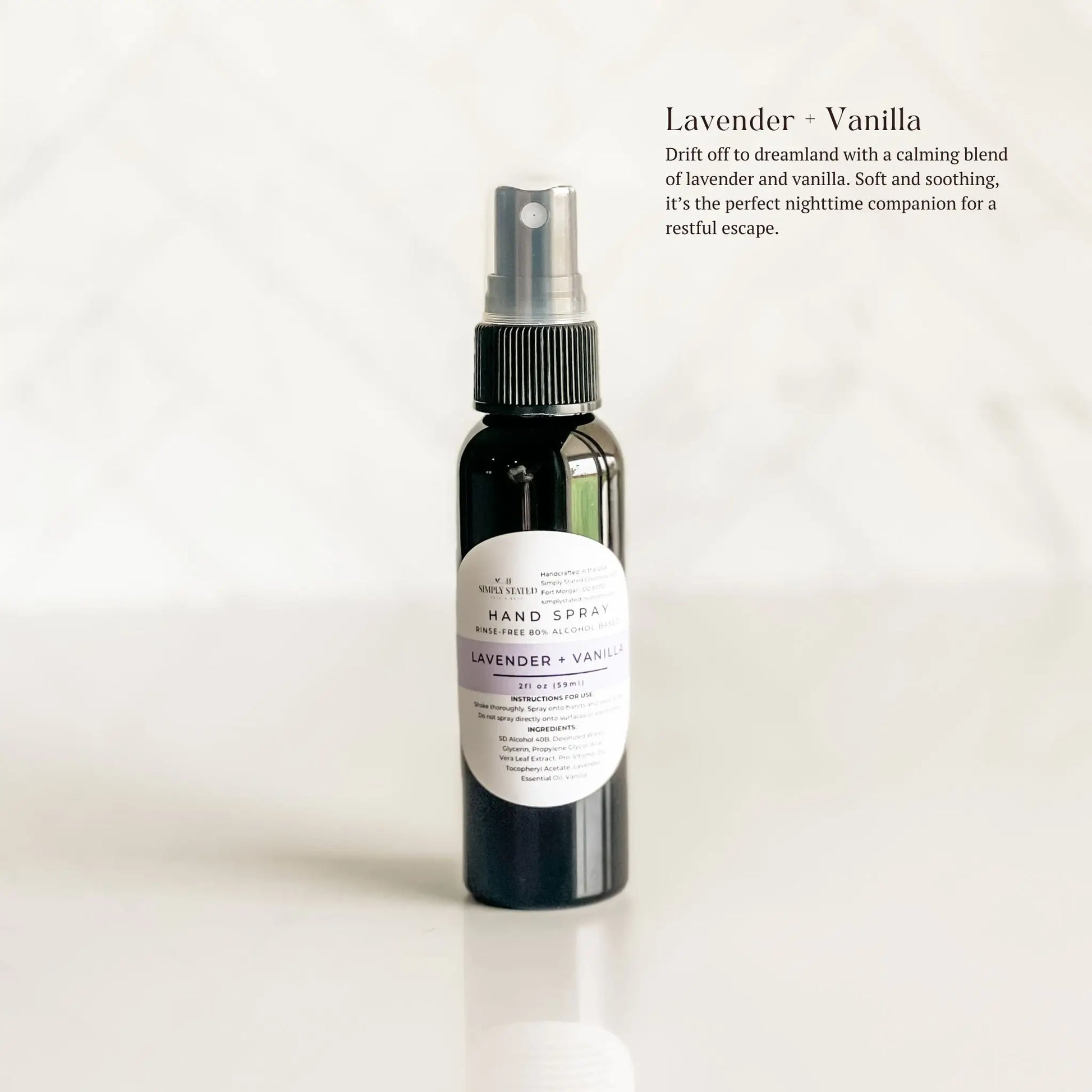 Hand spray bottle labeled 'Lavender + Vanilla' on a white background