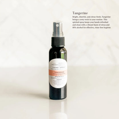 Hand spray bottle with tangerine scent on a white background
