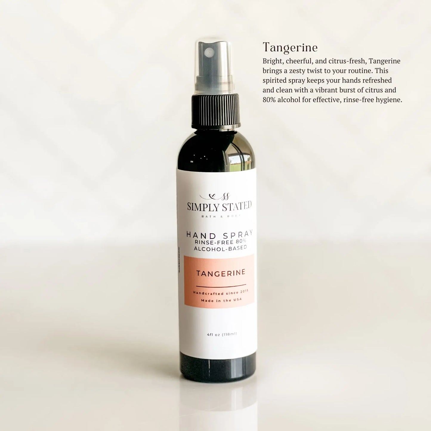 Hand spray bottle with tangerine scent on a white background