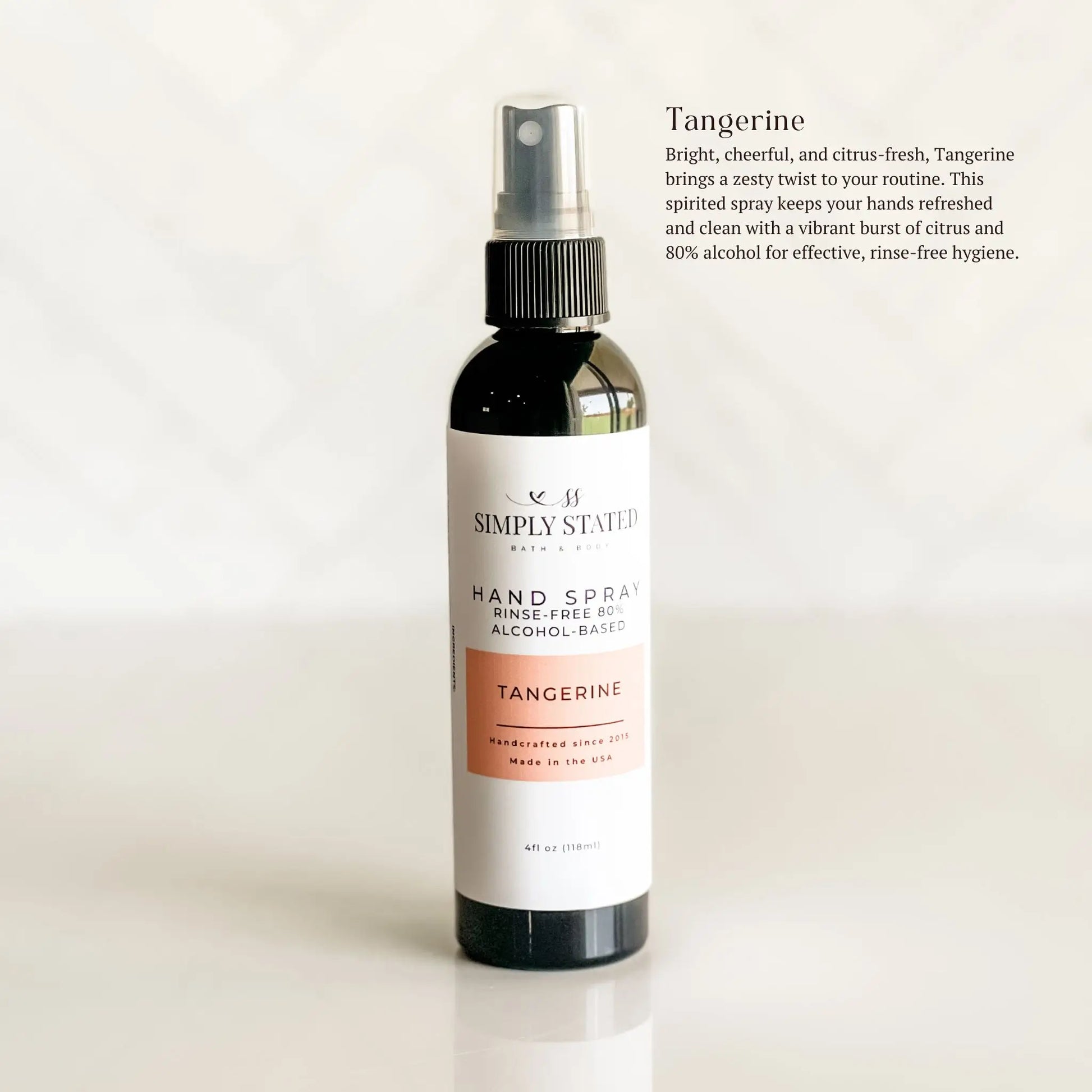 Hand spray bottle with tangerine scent on a white background