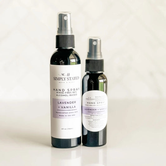 Two bottles of Simply Stated lavender and vanilla hand spray on a light background