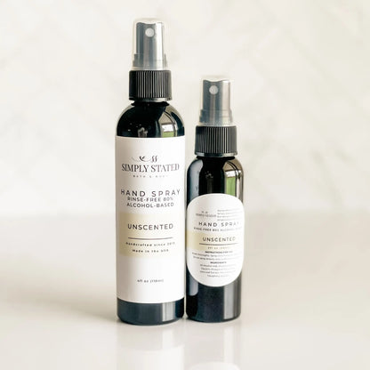 Two bottles of Simply Stated hand spray on a white background