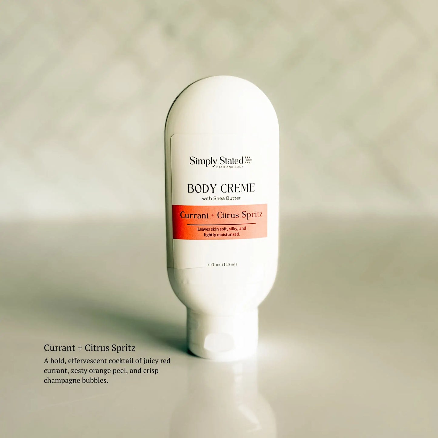 Body crème bottle labeled 'Simply Stated' on a neutral background
