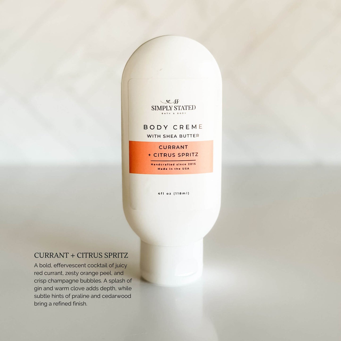 Simply Stated Body Crème in Currant Citrus Spritz scent, June Exclusive Scent of the Month. A juicy, refreshing blend of citrus and red currant with a summery red label.