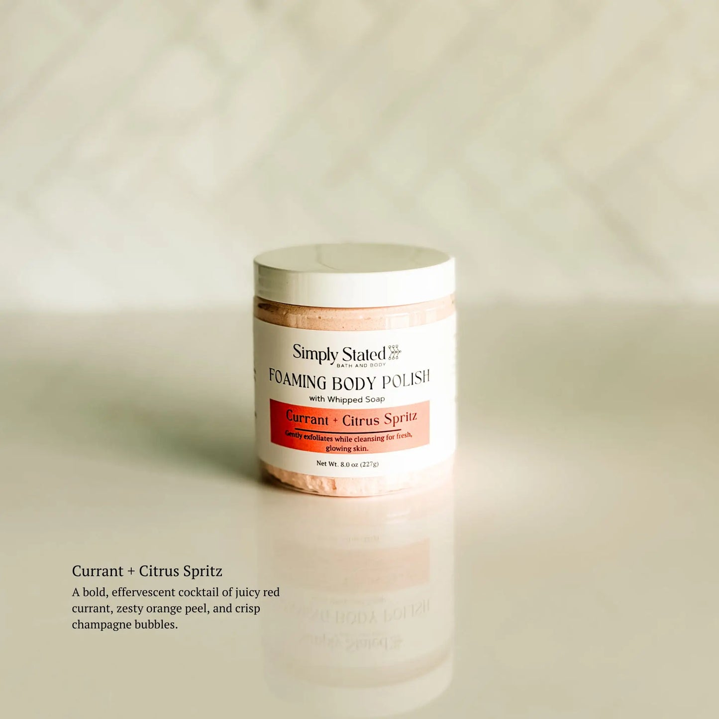 Foaming body polish jar labeled 'Simply Stated' on a beige background