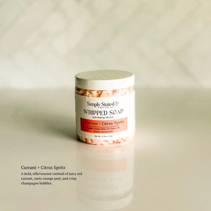Jar of whipped soap with a label on a beige background