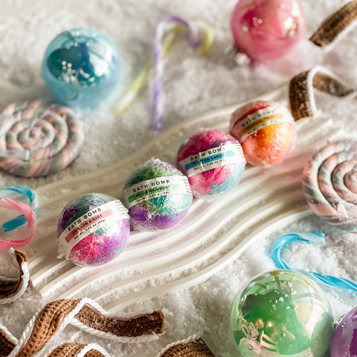 Simply Stated unicorn kisses, magic rainbow and cotton candy bath bombs with candy canes and iridescent ornaments
