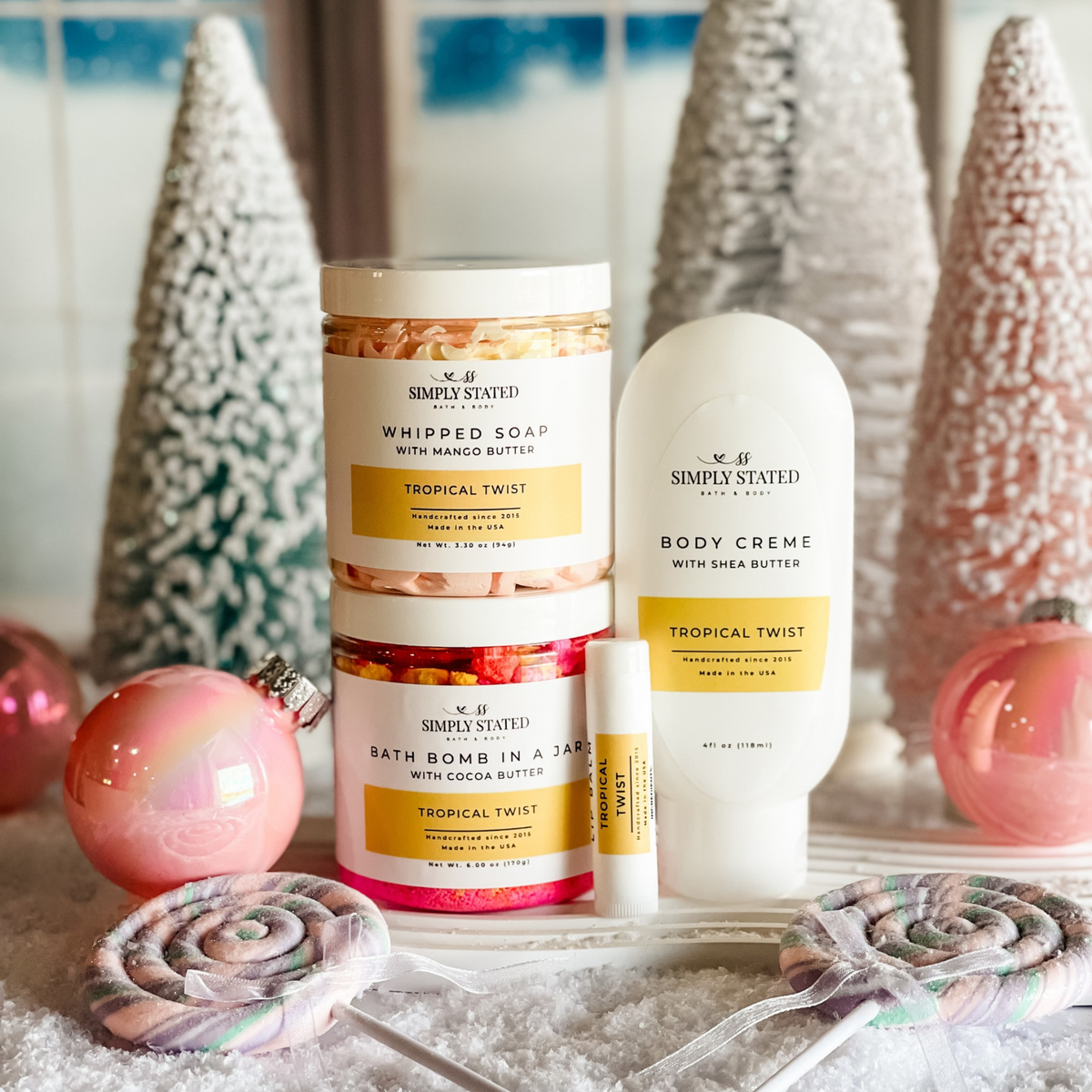 Simply Stated tropical twist whipped soap, bath bomb jar, body creme and lip balm with pastel trees and ornaments