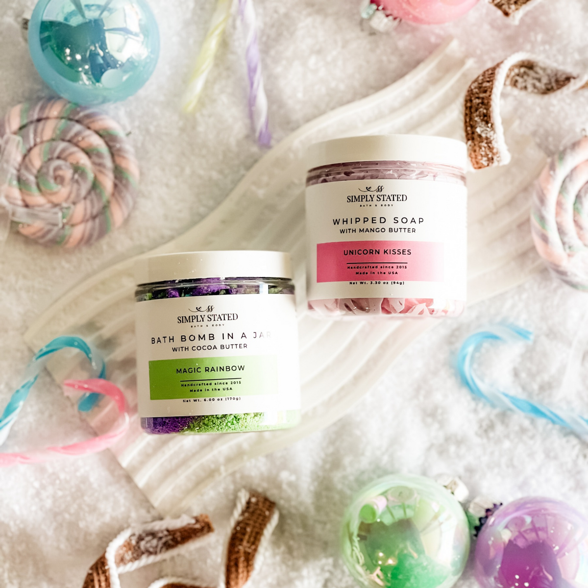 Simply Stated magic rainbow bath bomb in a jar and unicorn kisses whipped soap with candy canes and ornaments