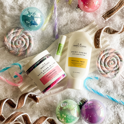 Simply Stated Tropical Twist Body Creme, Unicorn Kisses Bath Bomb in a Jar, and Magic Rainbow Lip Balm with candy and ornaments.
