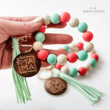 Bangle Keychain made with wood beads in solid mint green, coral, and cream. Mama wooden charm and tassle included.