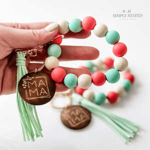 Bangle Keychain made with wood beads in solid mint green, coral, and cream. Mama wooden charm and tassle included.