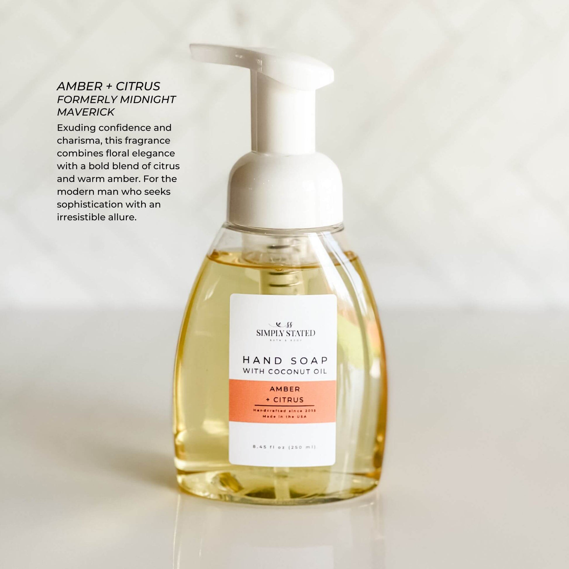 Amber + Citrus Men’s Foaming Hand Soap in white bottle with bold orange label