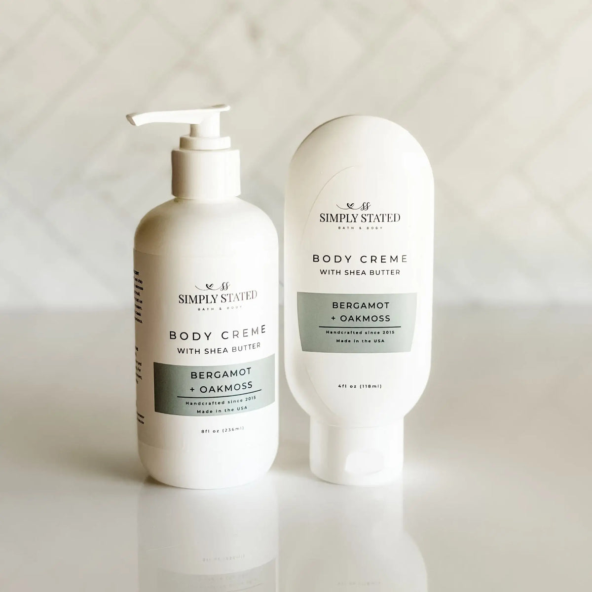 Simply Stated Bath & Body Body Creme with Shea Butter in Bergamot + Oakmoss, pump bottle and tube shown together