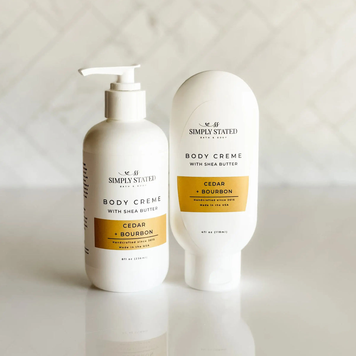 Simply Stated Bath & Body Body Creme with Shea Butter in Cedar + Bourbon, pump bottle and tube shown together