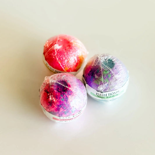 Three colorful bath bombs on a light background