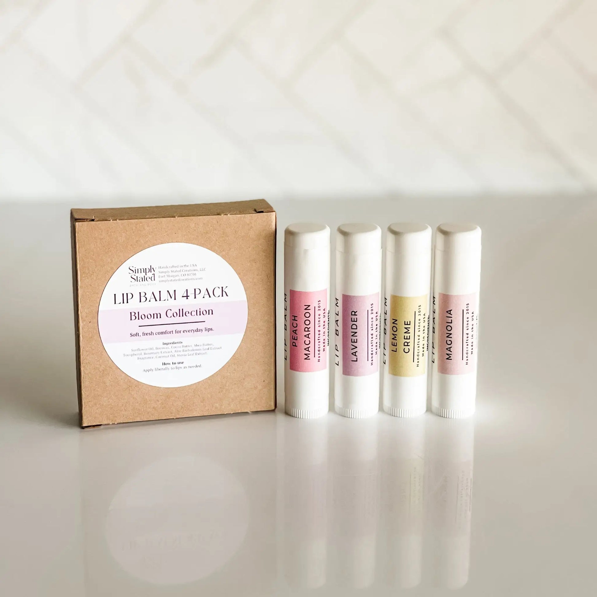 Lip Balm Box with 4 lip balm flavors in Peach Macaroon, Lavender, Lemon Creme, and Magnolia. 