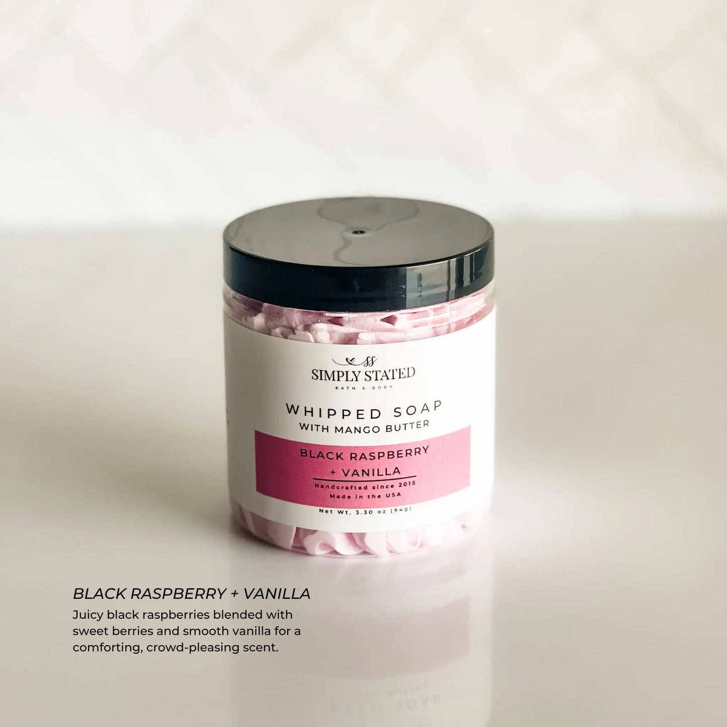 Jar of whipped soap with black raspberry and vanilla scent on a white background