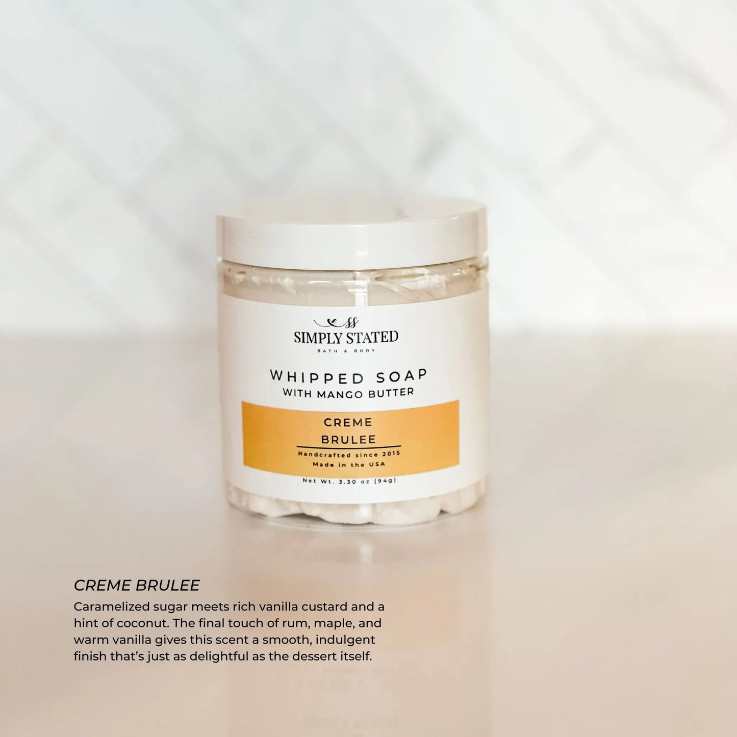 Jar of whipped soap labeled Creme Brulee on a white background