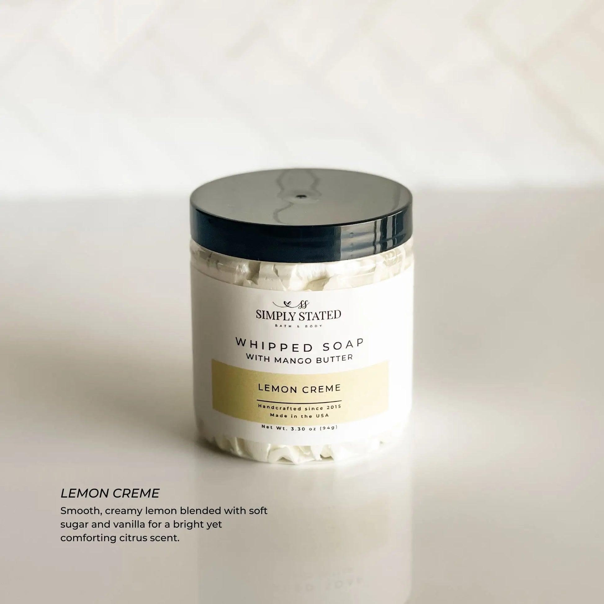 Jar of Simply Stated Lemon Creme whipped soap on a white background