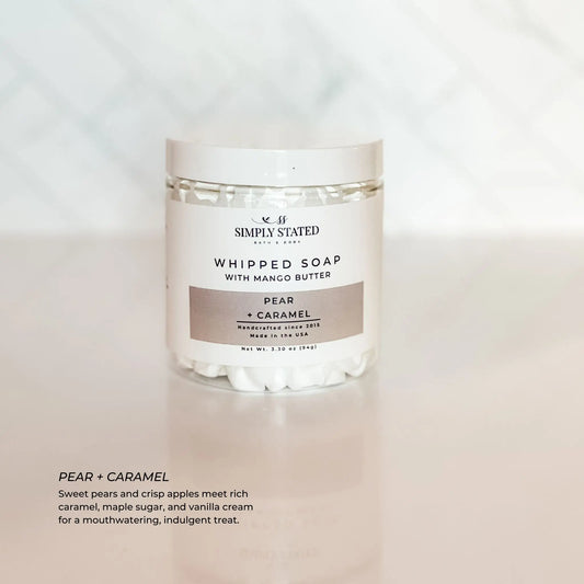 Jar of whipped soap labeled 'Pear + Caramel' by Simply Stated on a light background