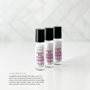 Winter Collection Roll-On Perfume in Cashmere Plum. Scent description "A delightful blend of bright citrus and a touch of black cherry, enhancing the heart of dark plum to create a truly fruit-forward experience. As you inhale, the sweet notes of amber, sugar, and vanilla unfold, reinforcing the richness of this exquisite scent."