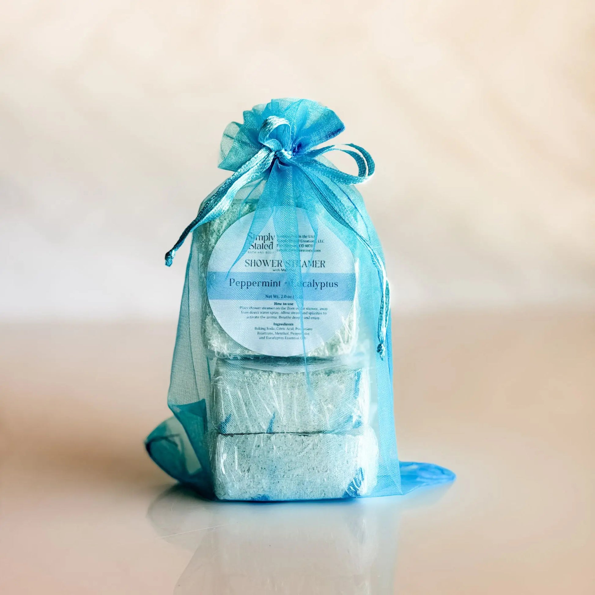 Simply Stated Peppermint Eucalyptus Shower Steamer 3-Pack in blue organza bag — gift-ready menthol steamers handcrafted in Colorado
