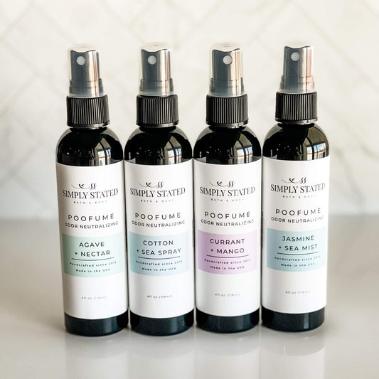 Group of four Simply Stated Poofume 4oz bottles with agave + nectar, cotton + sea spray, currant + mango, and jasmine + sea mist scents.