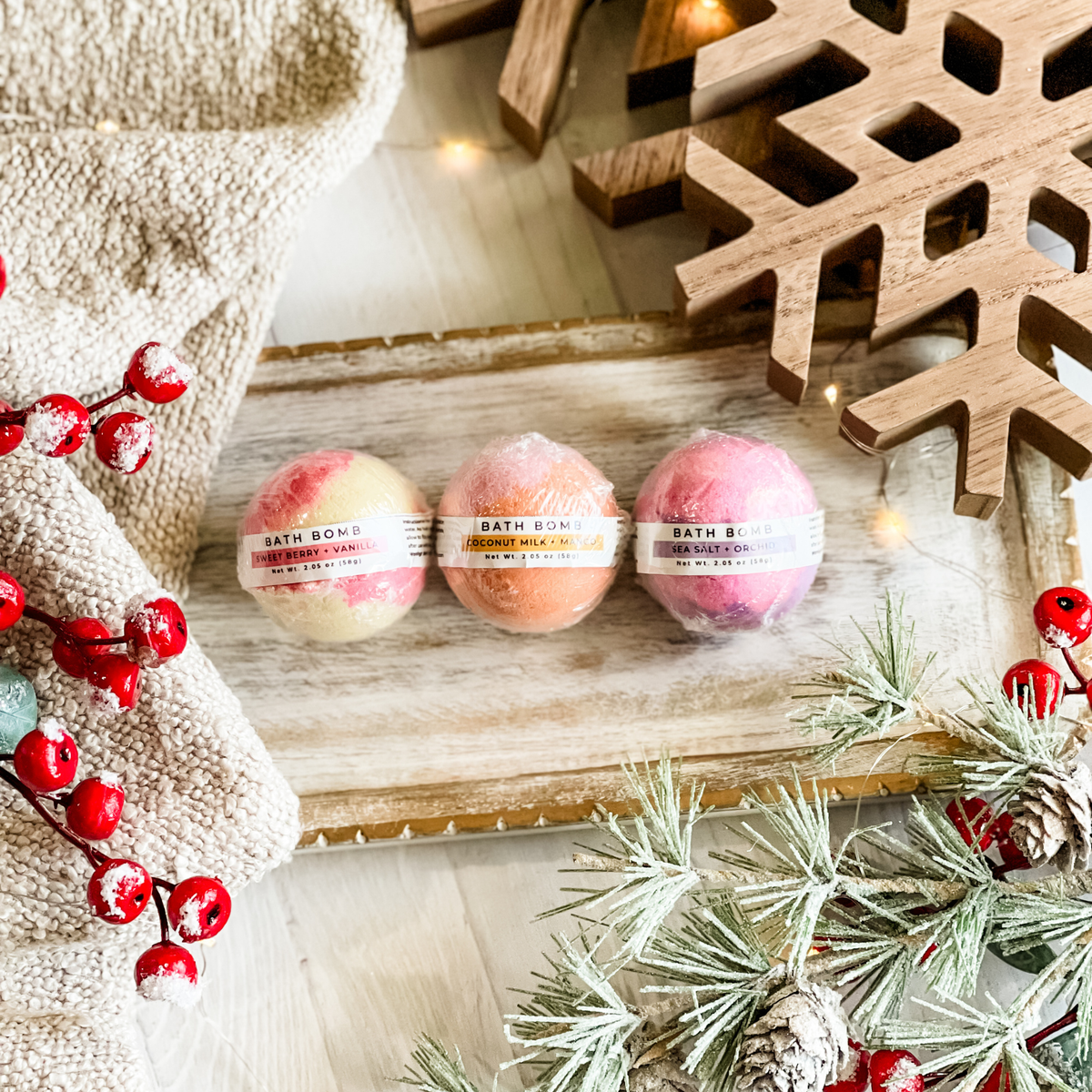 Simply Stated Bath Bomb trio, Sweet Berry + Vanilla, Coconut Milk + Mango, Sea Salt + Orchid, with berries and pine.