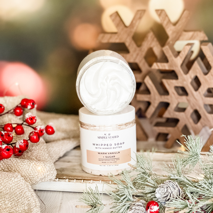 Simply Stated warm vanilla sugar whipped soap with mango butter beside holiday berries and wooden snowflakes