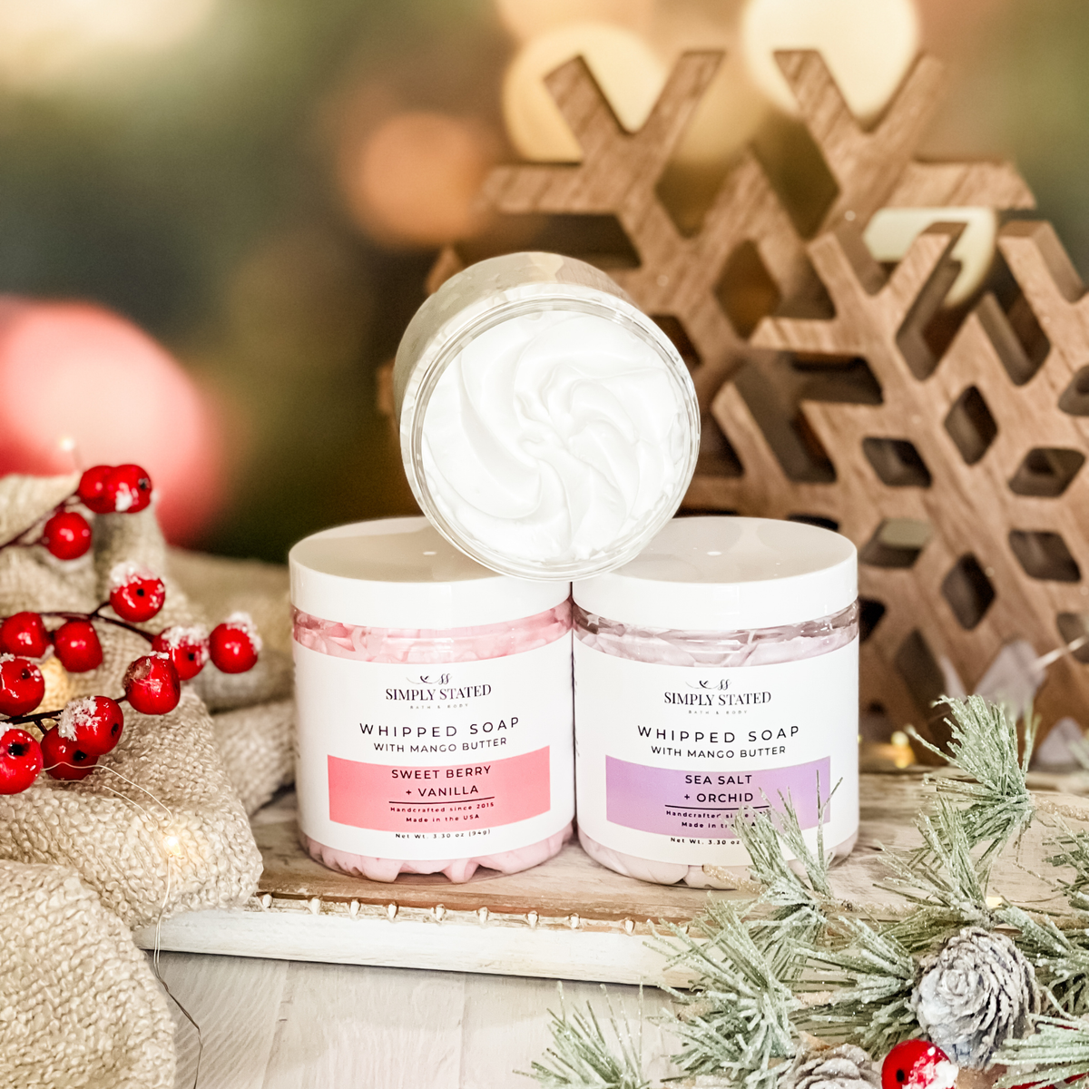Simply Stated whipped soap with mango butter in sweet berry vanilla and sea salt orchid beside holiday berries