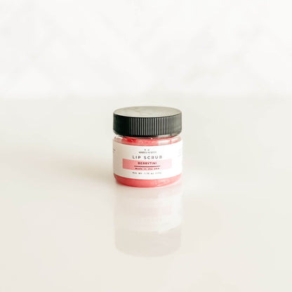 Berrytini lip scrub from Simply Stated Bath & Body, showcasing a pink-tinted sugar scrub with a sleek black lid and signature label.