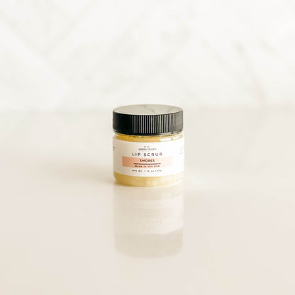 Simply Stated s'mores lip scrub in a clear jar with a creamy, marshmallow-tinted formula, offering a blend of graham cracker, chocolate, and marshmallow aromas.